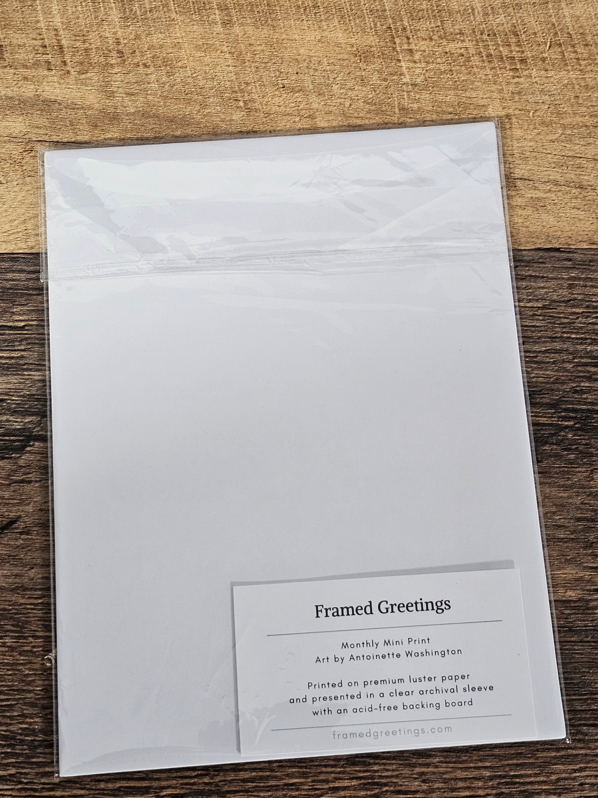 White greeting card with text on a wooden surface