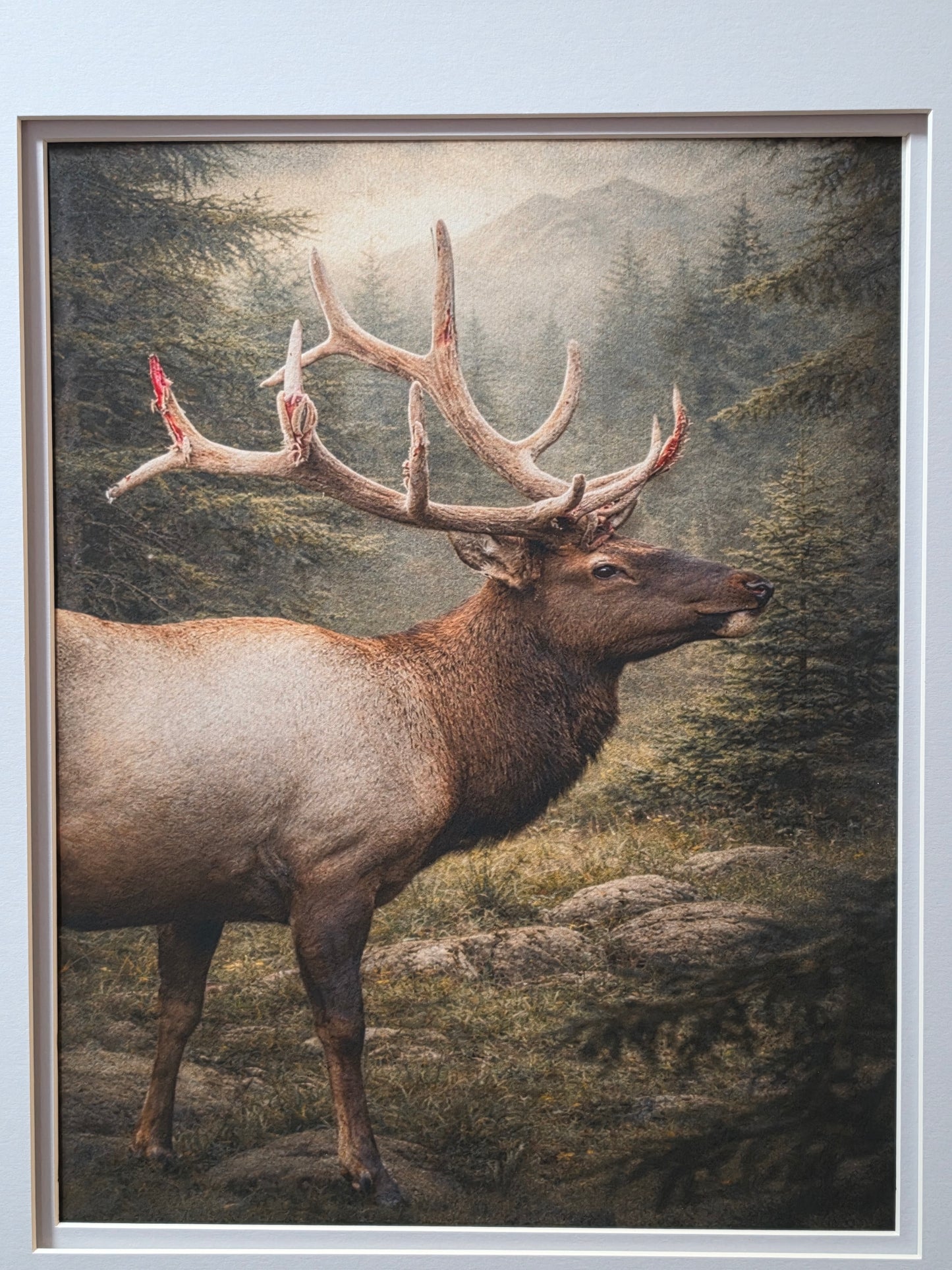 Framed artwork of a deer with large antlers against a natural landscape.