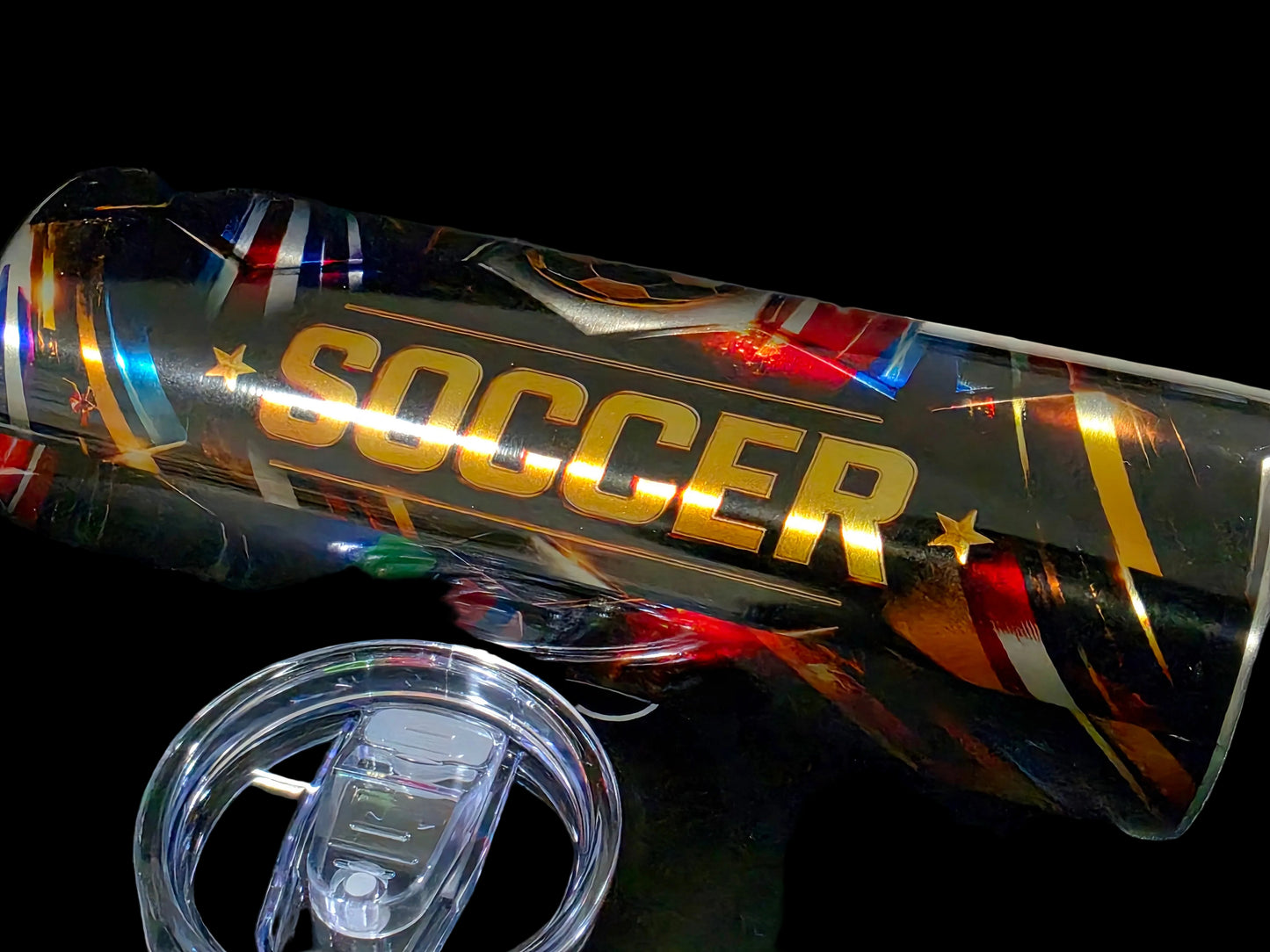 Colorful tumbler with 'SOCCER' text on a dark surface