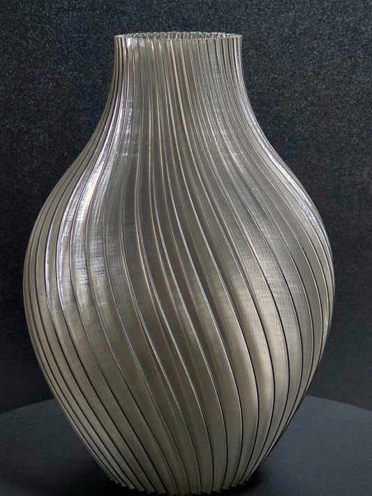 Translucent gray sculpted vase on a dark background