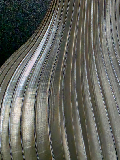 Close-up of a translucent gray vase with ribbed texture on a dark background