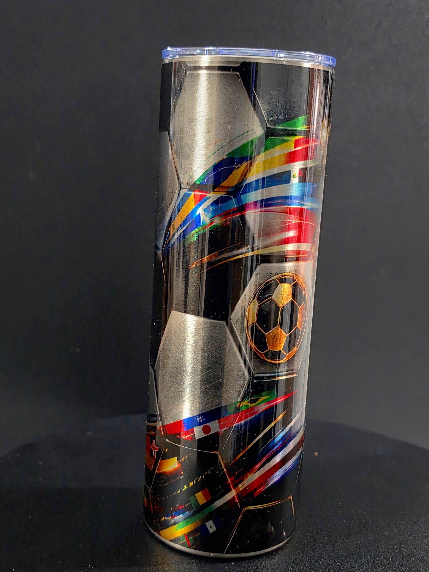 Soccer-themed tumbler with colorful design on a black background