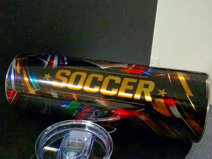 Metallic cup with 'SOCCER' text and international flags on a dark background