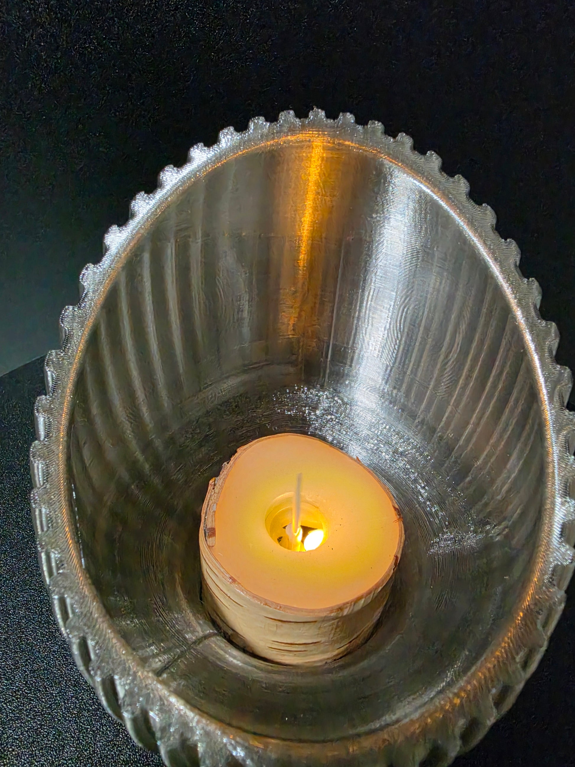 Candle in a decorative  holder on a dark background